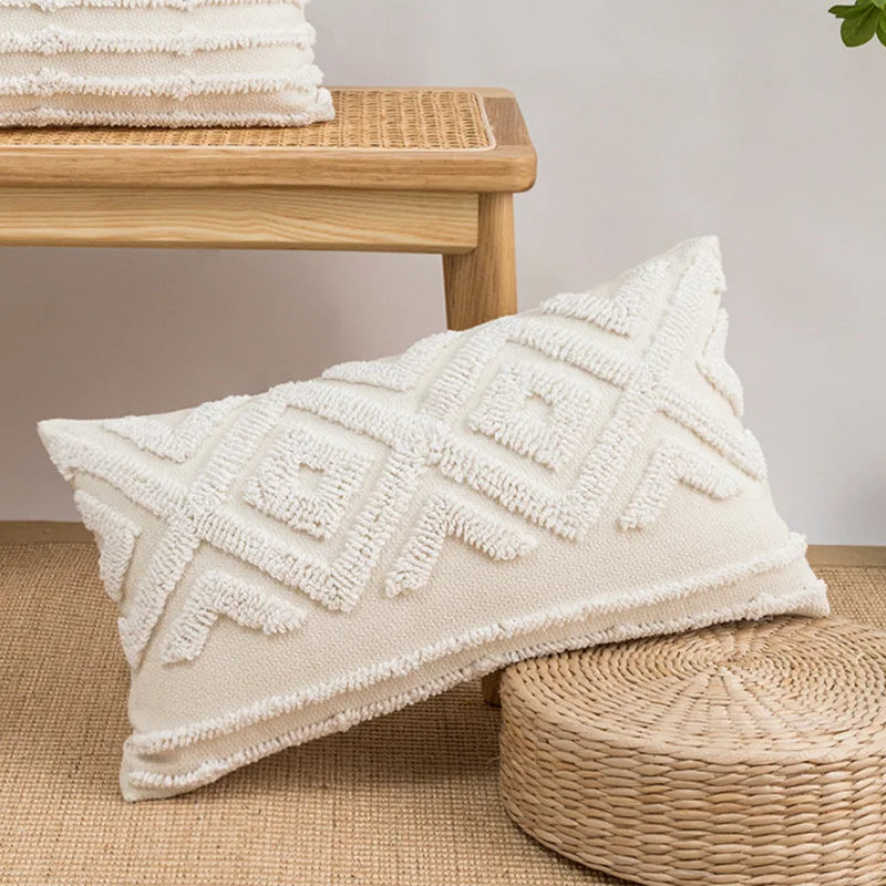 Textured white pillow on a woven surface with a wooden bench in the background Nordic blue tufted cushion cover with geometric stripe and grid crochet pattern, tassel pillow cover for sofa, bed, and boho home decor