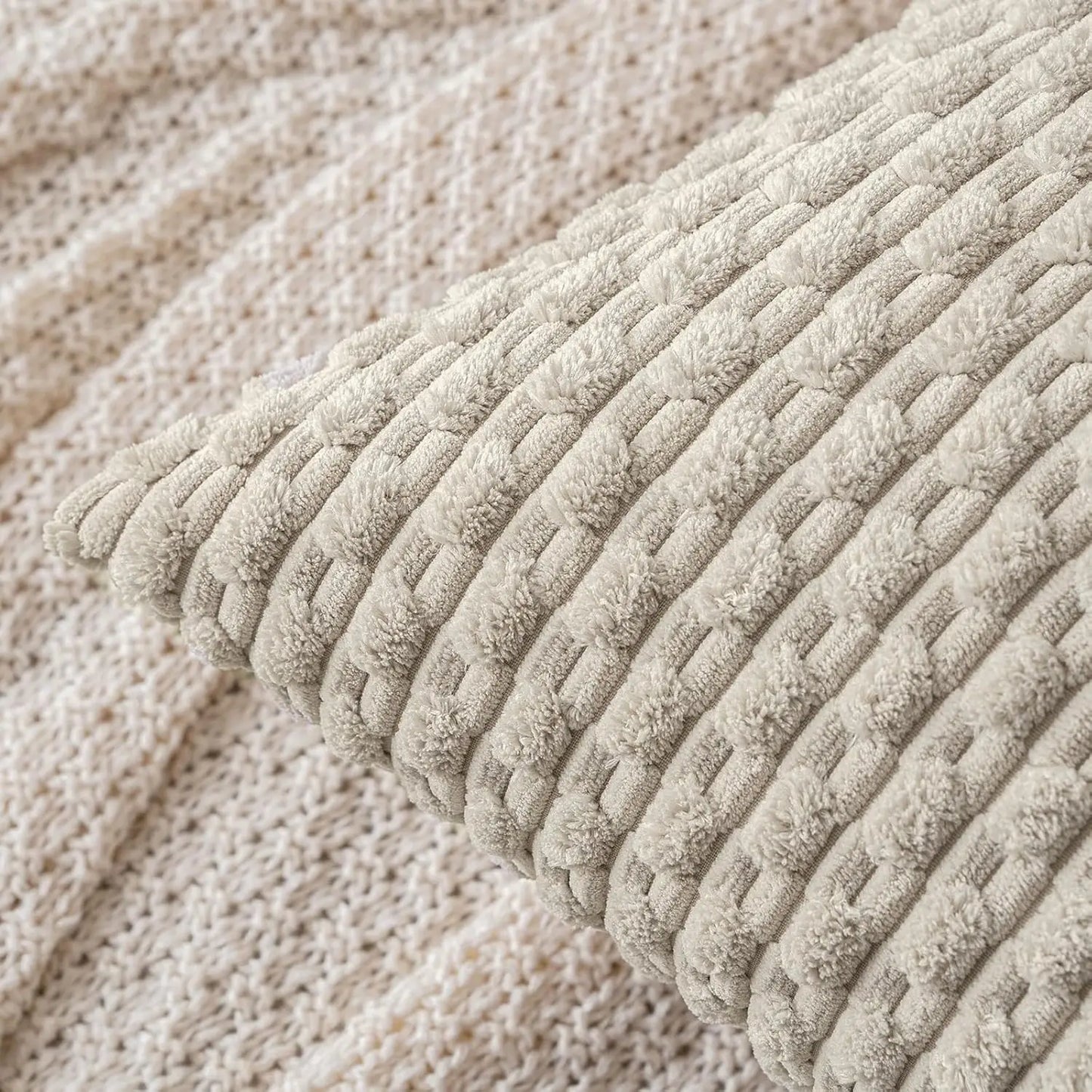 Close-up of a textured beige pillow with a woven pattern.