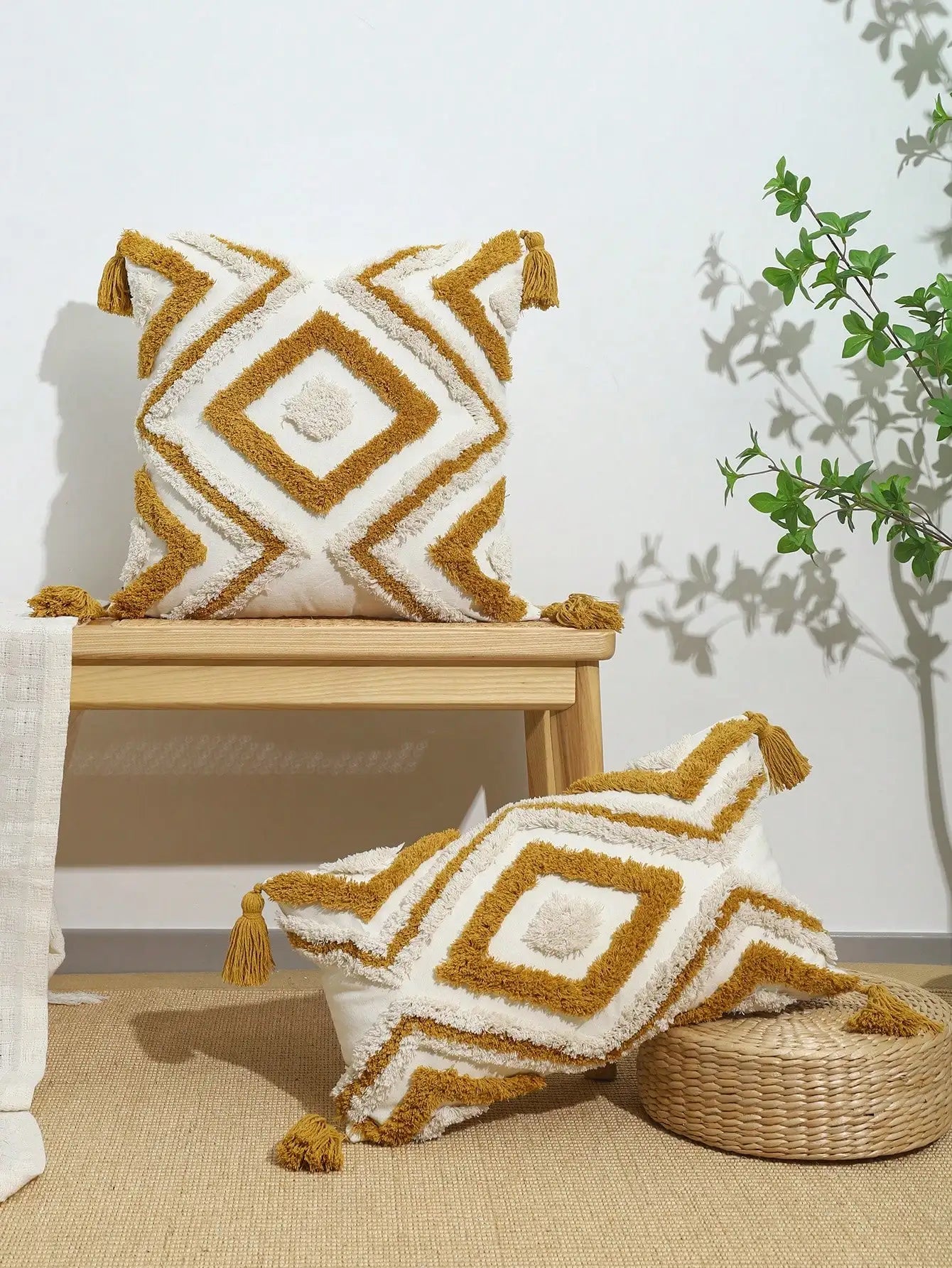 Decorative pillows with geometric pattern on a wooden stool and woven basket against a white wall. Nordic Moroccan tufted throw pillow cover in geometric jacquard design, boho accent cushion for sofa, bed, or car, available in 12x20 inch lumbar and 18x18 inch square sizes – cozy textured boho home decor.