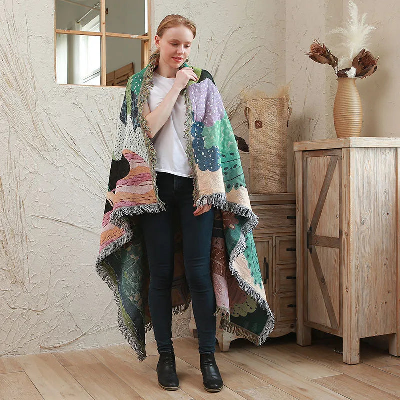 Woman wearing a colorful knitted shawl in a home setting. Boho Home Decor.