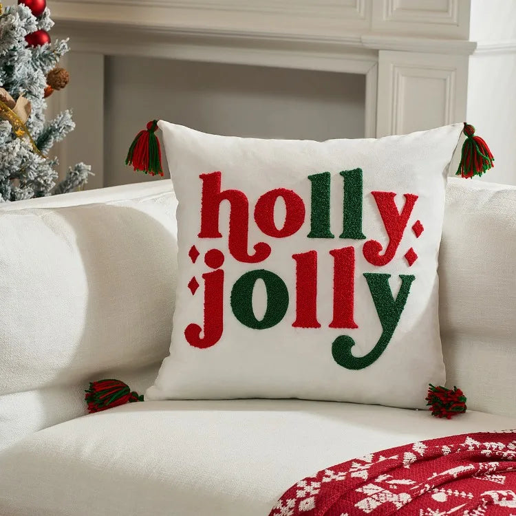 Decorative pillow with 'holly jolly' text on a couch in a festive setting.