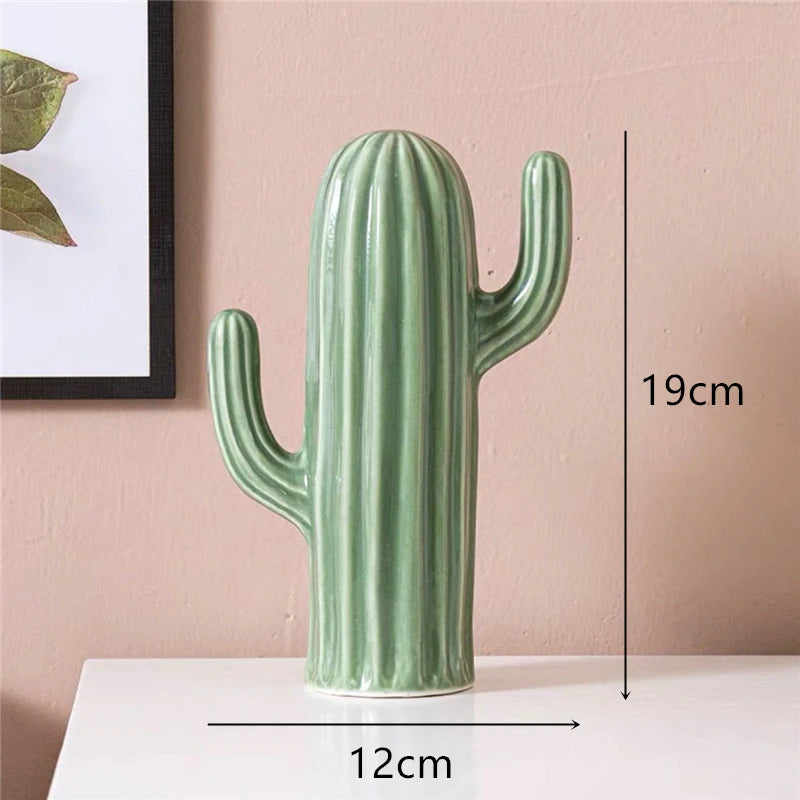 Green cactus-shaped vase with measurements on a pink background. Modern ceramic cactus figurine for home or office decoration. House warming gift.
