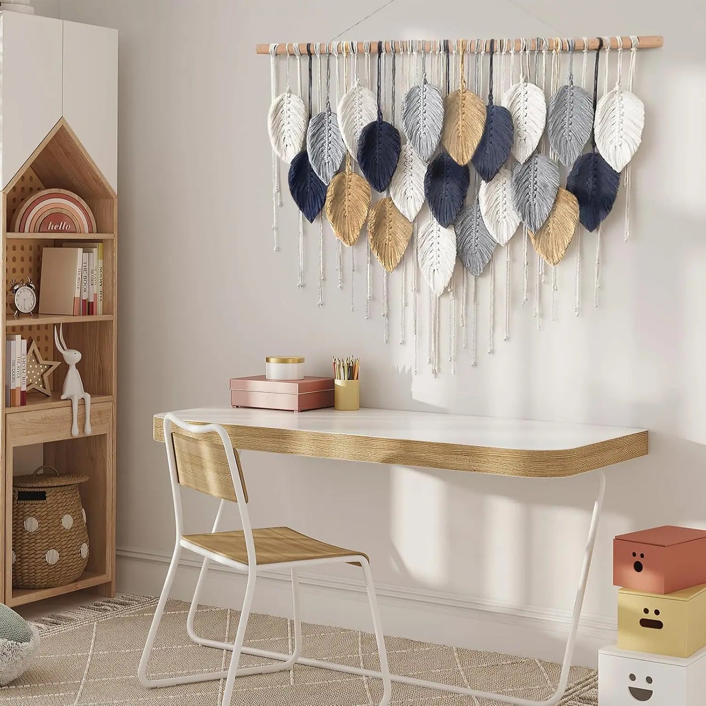 Modern home office with a desk, chair, and decorative wall hanging.