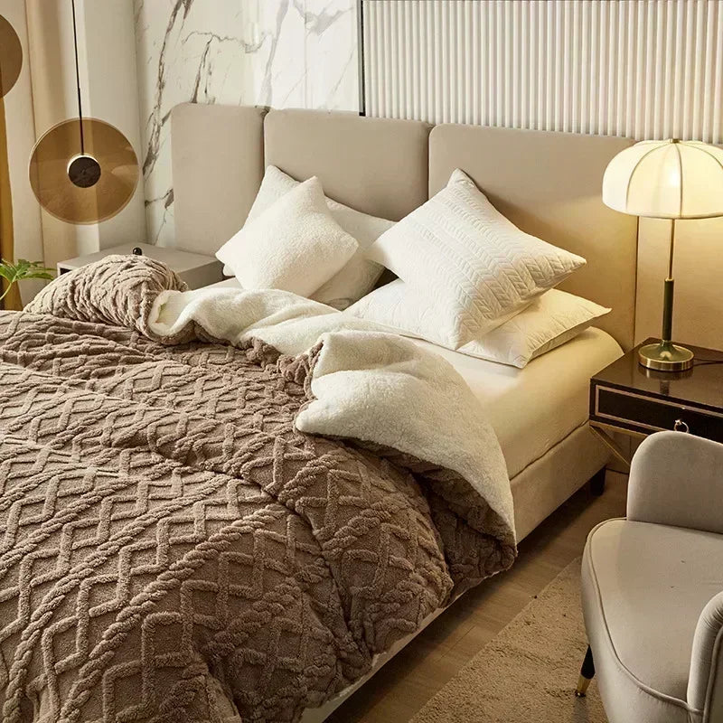 Neatly made bed with beige and white bedding in a bedroom setting. Soft plush duvet cover and blanket in solid color with striped jacquard design, dual-use artificial cashmere fleece bedding for cozy winter warmth