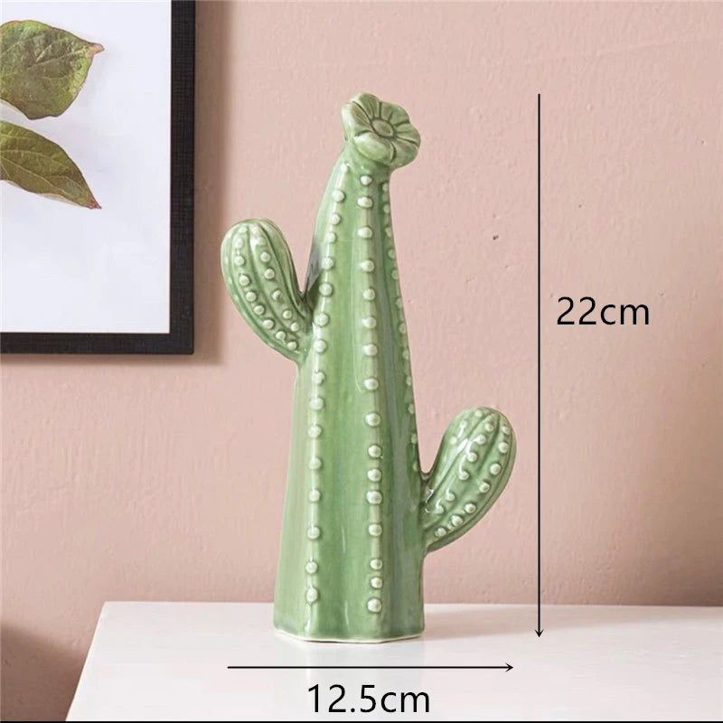 Green ceramic cactus decoration with measurements on a pink wall background. Modern ceramic cactus figurine for home or office decoration. House warming gift.