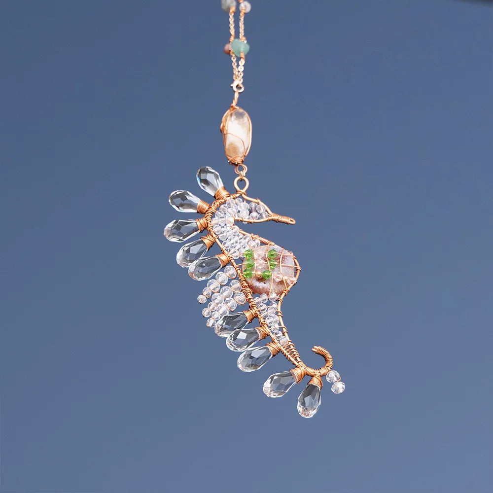 Delicate crystal pendant seahorse with gold accents on a dark blue background boho home decor, crystal wind chime, sun catcher for windows, moon prism chime, agate stone hanging, garden art decor, patio hanging decoration, boho housewarming gift, spiritual gift, crystal suncatcher, balcony decor, meditation decor, handmade crystal chime