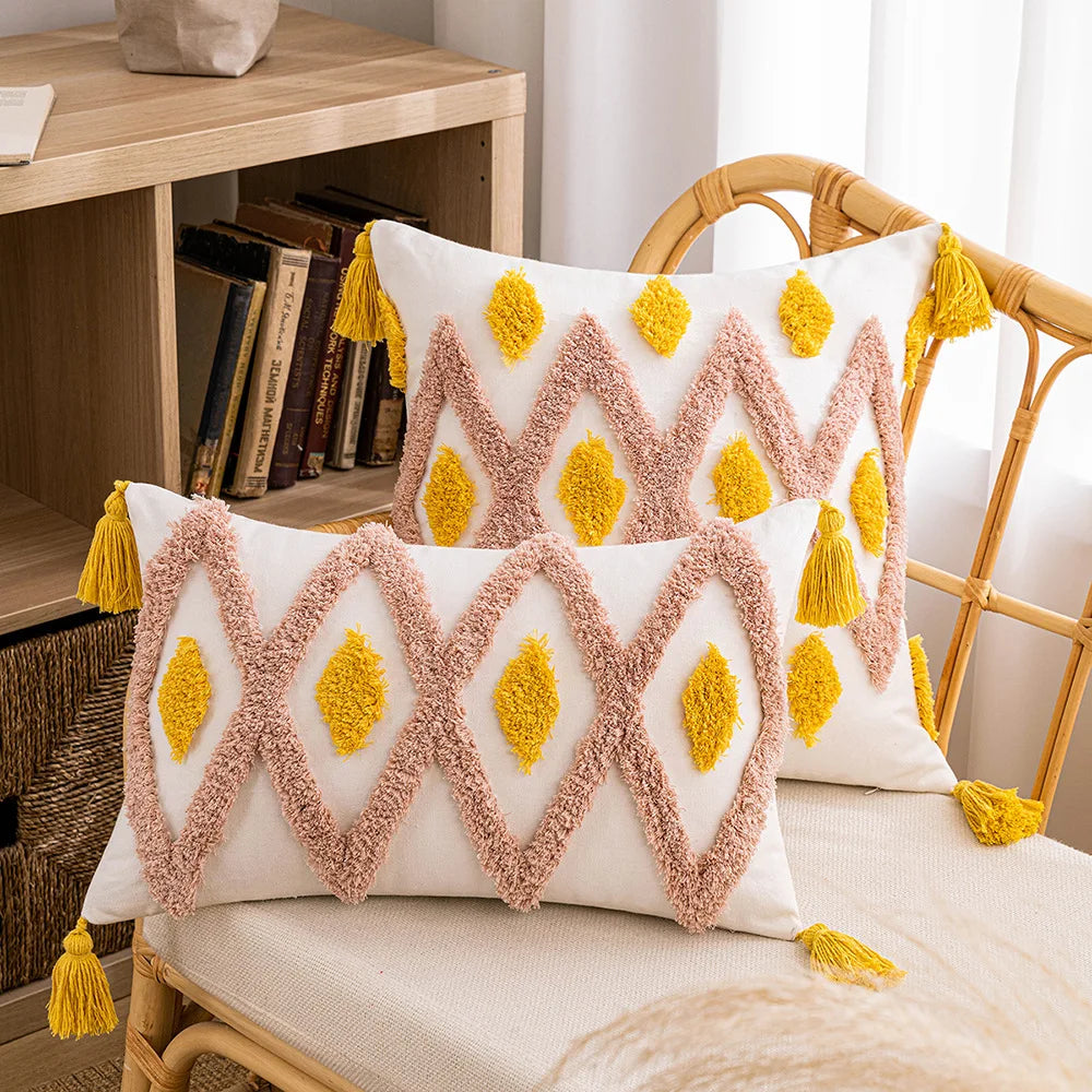 Decorative pillows with geometric patterns and tassels on a chair. Decorative tassel cushion cover