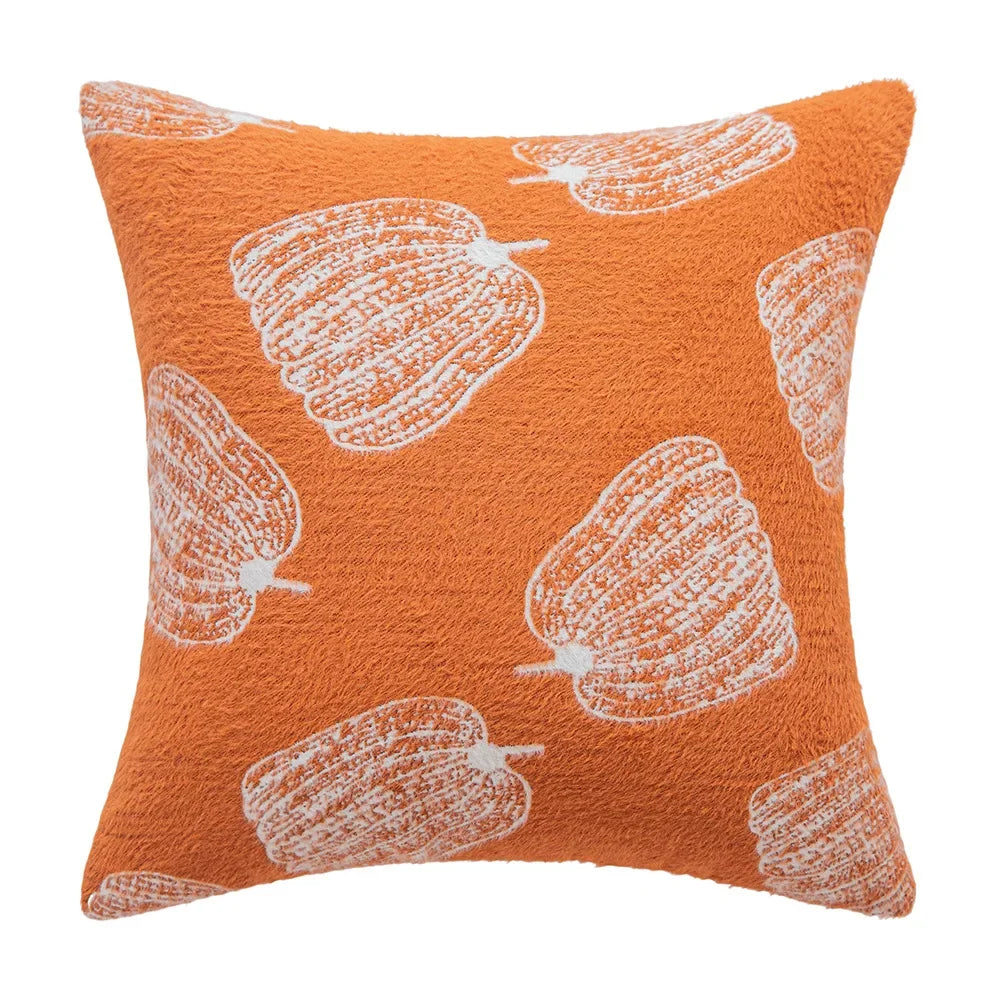 Orange pillow with white pattern on a white background. Cozy fall pumpkin pillow cover for living room or bedroom.