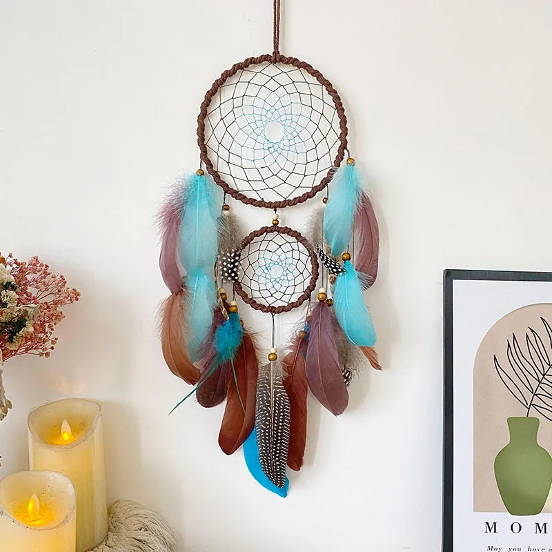 Dreamcatcher with feathers hanging on a white wall with candles and a framed picture. boho home decor, housewarming gift, dream catcher wall hanging, feather wind chime, handmade dreamcatcher, colorful boho wall decor, birthday gift decor, modern bohemian style, bedroom hanging ornament, spiritual home decor, dreamcatcher nursery decor