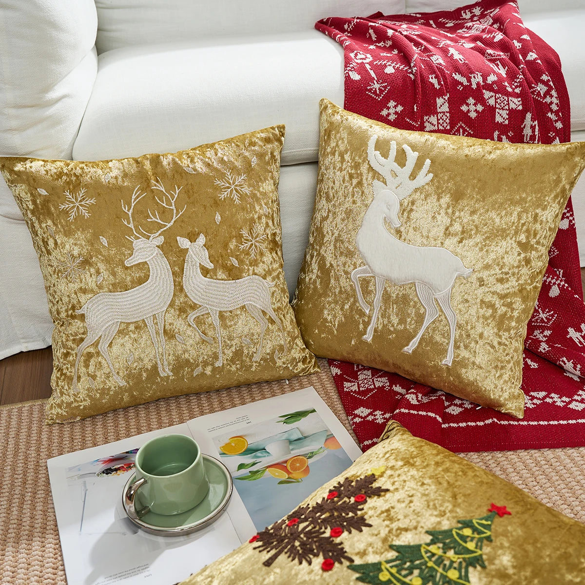 Gold velvet pillows with reindeer designs on a couch with a red blanket and magazine. Christmas embroidered pillow cover in gold, 18x18 inch festive cushion case for sofa, bed, or holiday home décor. Christmas Gift Ideas
