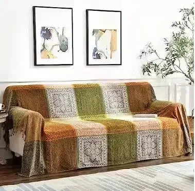 Patterned sofa cover draped over a wooden sofa in a living room setting.