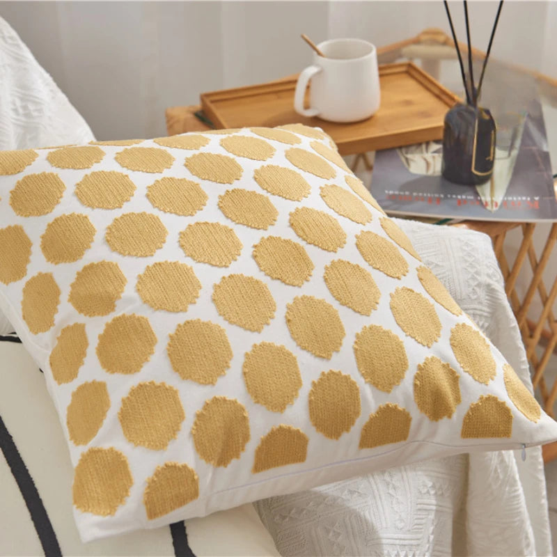 Decorative pillow with yellow circular pattern on a white background