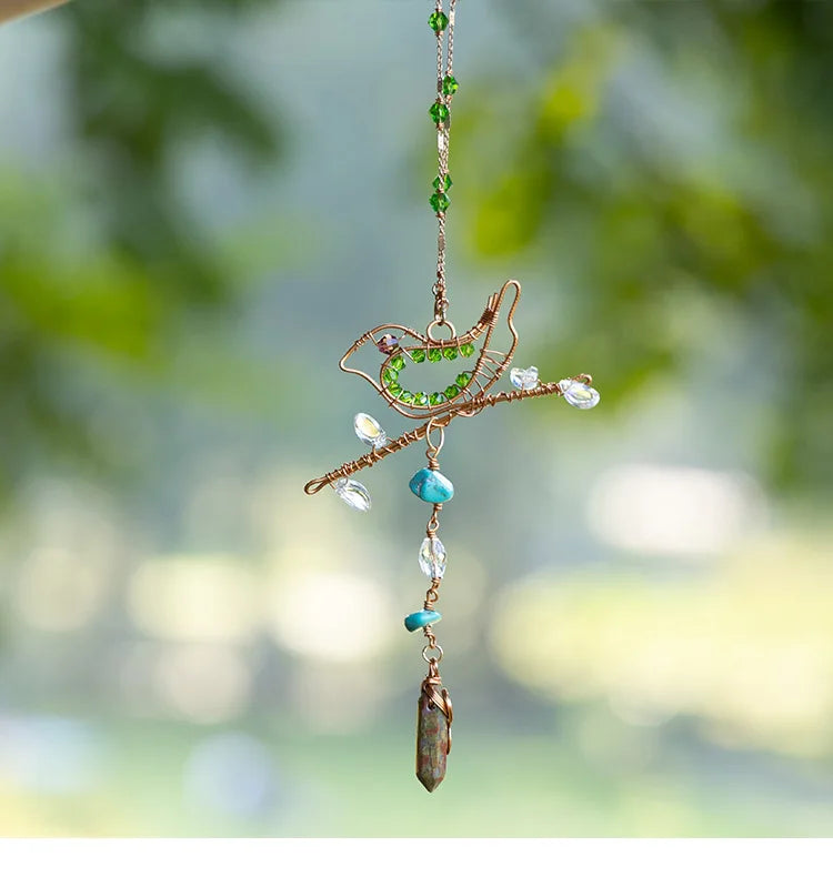 Decorative hanging bird ornament with beads and stones against a blurred natural background boho home decor, crystal wind chime, sun catcher for windows, moon prism chime, agate stone hanging, garden art decor, patio hanging decoration, boho housewarming gift, spiritual gift, crystal suncatcher, balcony decor, meditation decor, handmade crystal chime