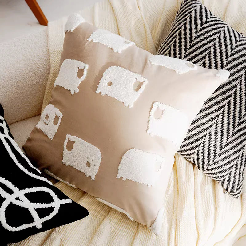 Decorative pillow with sheep pattern on a couch