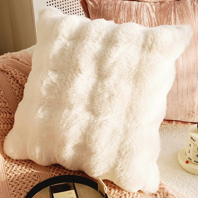 Fluffy white pillow on a textured surface with a blurred background. Boho Home Decor.