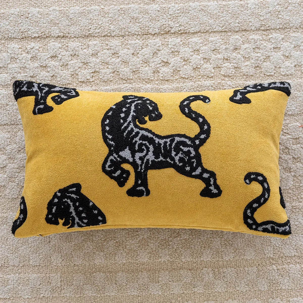 Yellow pillow with black panther design on a textured surface.embroidery throw pillow cover in boho modern style