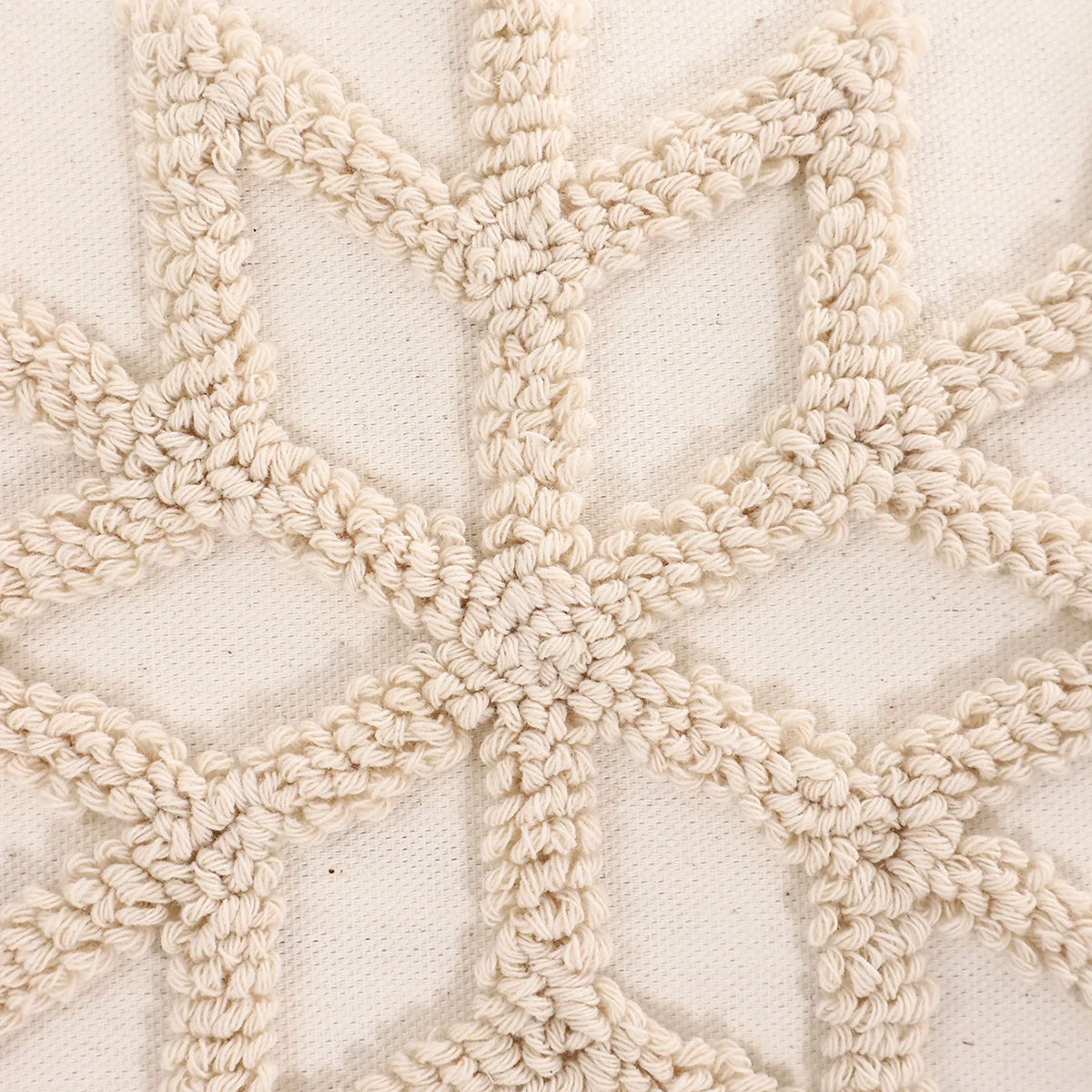 Close-up of a textured beige fabric with a geometric pattern. Christmas embroidered pillow cover with tufted snowflake and reindeer design in 18x18 inches, festive canvas cushion case for sofa or bed