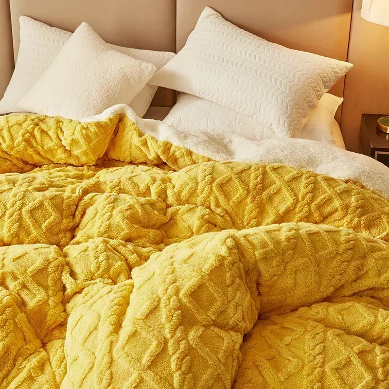 Yellow textured blanket on a bed with white pillows. Soft plush duvet cover and blanket in solid color with striped jacquard design, dual-use artificial cashmere fleece bedding for cozy winter warmth