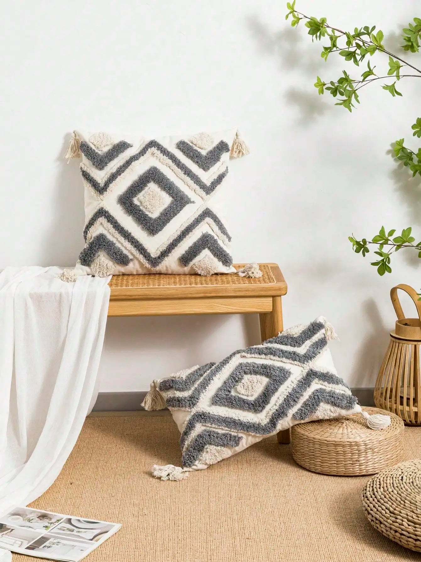 Decorative pillows with geometric patterns on a wooden stool and floor in a home setting. Nordic Moroccan tufted throw pillow cover in geometric jacquard design, boho accent cushion for sofa, bed, or car, available in 12x20 inch lumbar and 18x18 inch square sizes – cozy textured boho home decor.