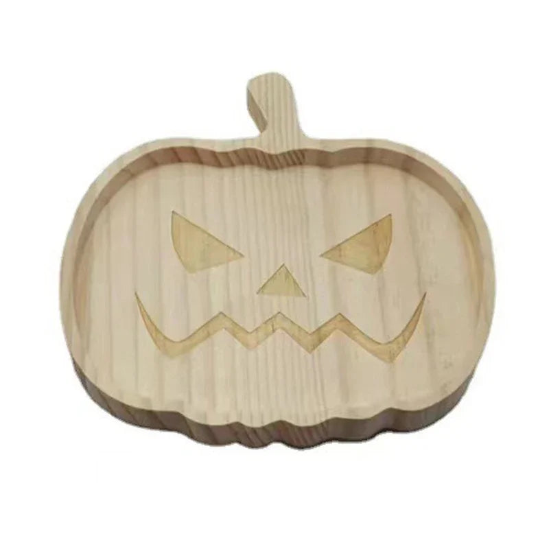 Wooden pumpkin-shaped cutting board with a carved face on a white background. Wooden Halloween serving tray in pumpkin and ghost shapes, rustic snack and dessert plate for party décor and fall entertaining