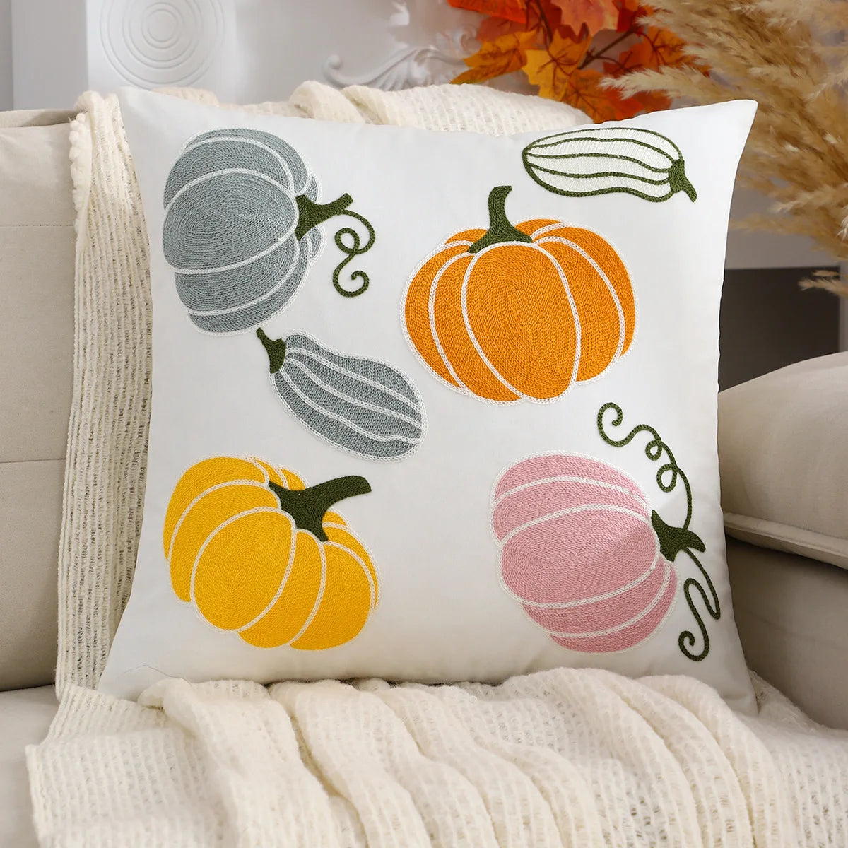 Decorative pillow with pumpkins on a couch