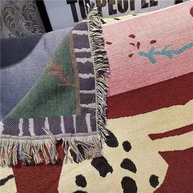 Close-up of a patterned fabric with fringe on a textured surface Leopard design boho home decor blanket, decorative woven tapestry for living room or bedroom