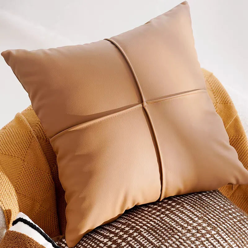 Beige pillow on a textured surface with a neutral background
