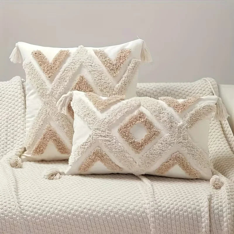Decorative pillows with geometric patterns on a textured surface Nordic Bohemian geometric plush pillow cover with embroidered design and tassels, perfect for boho home decor on sofa, bed, or accent chair β cozy neutral cushion cover for living room or bedroom style