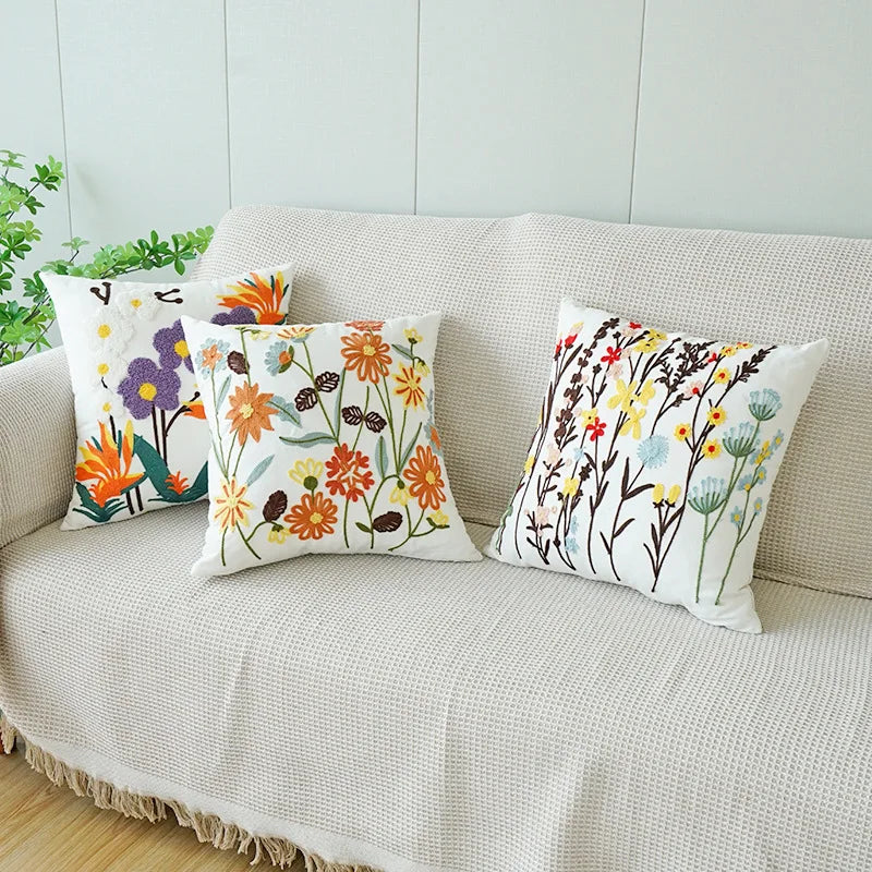 Decorative pillows with floral patterns on a beige sofa. Floral embroidered throw pillow cover boho decor