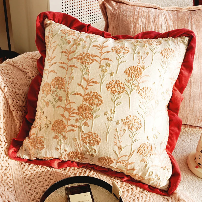 Decorative pillow with floral pattern and red trim on a textured surface. Boho Home Decor.