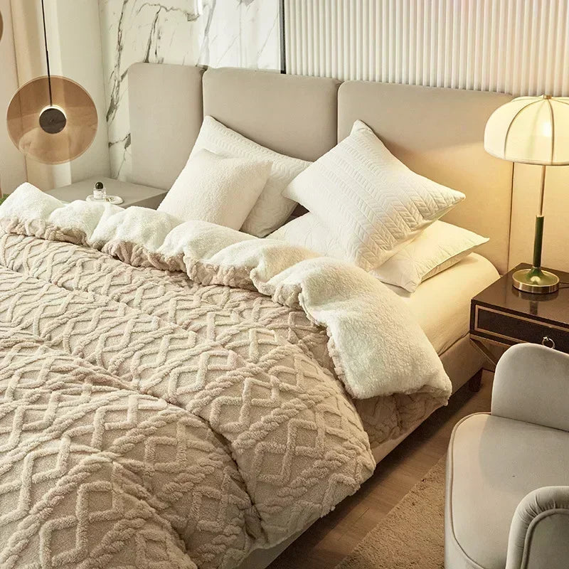 Neatly made bed with beige comforter and pillows in a well-lit bedroom. Soft plush duvet cover and blanket in solid color with striped jacquard design, dual-use artificial cashmere fleece bedding for cozy winter warmth.