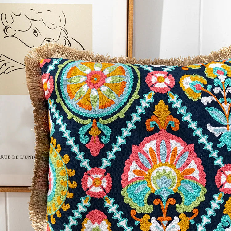 Decorative pillow with colorful embroidery on a neutral background. Bohemian embroidered throw pillow cover with geometric design, cotton-blend cushion for sofa, bed, or modern home decor.