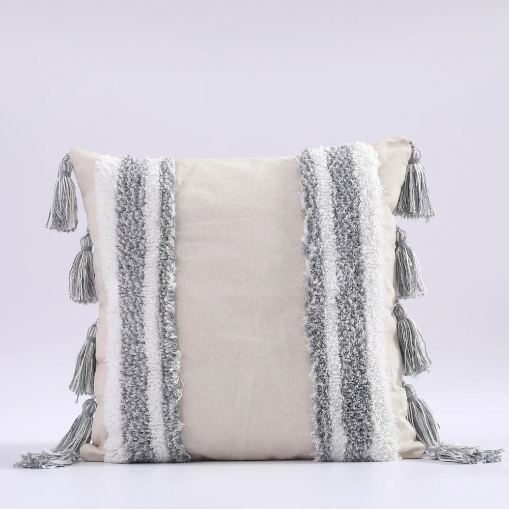 Decorative pillow with tassels on a light gray background