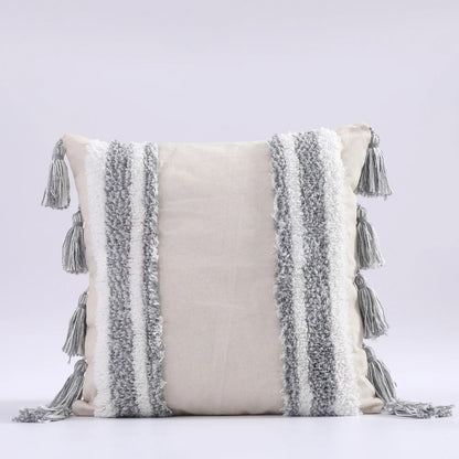 Decorative pillow with tassels on a light gray background