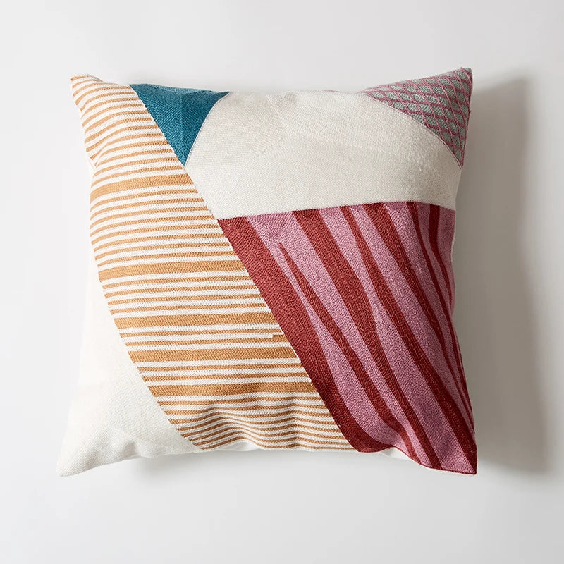 Colorful geometric-patterned pillow on a white background Colorful abstract geometric embroidered cushion cover in cotton blend, decorative pillowcase for living room, kids’ room, or boho home decor.
