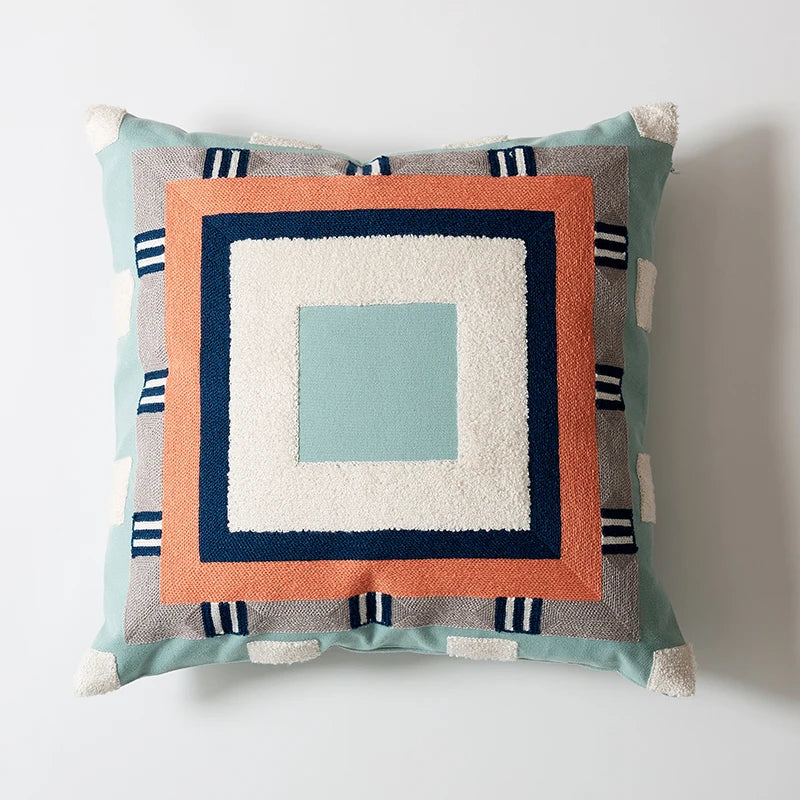 Decorative pillow with geometric pattern on a white background Colorful abstract geometric embroidered cushion cover in cotton blend, decorative pillowcase for living room, kids’ room, or boho home decor.