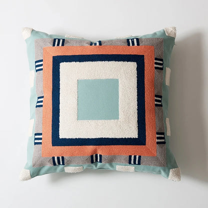 Decorative pillow with geometric pattern on a white background Colorful abstract geometric embroidered cushion cover in cotton blend, decorative pillowcase for living room, kids’ room, or boho home decor.