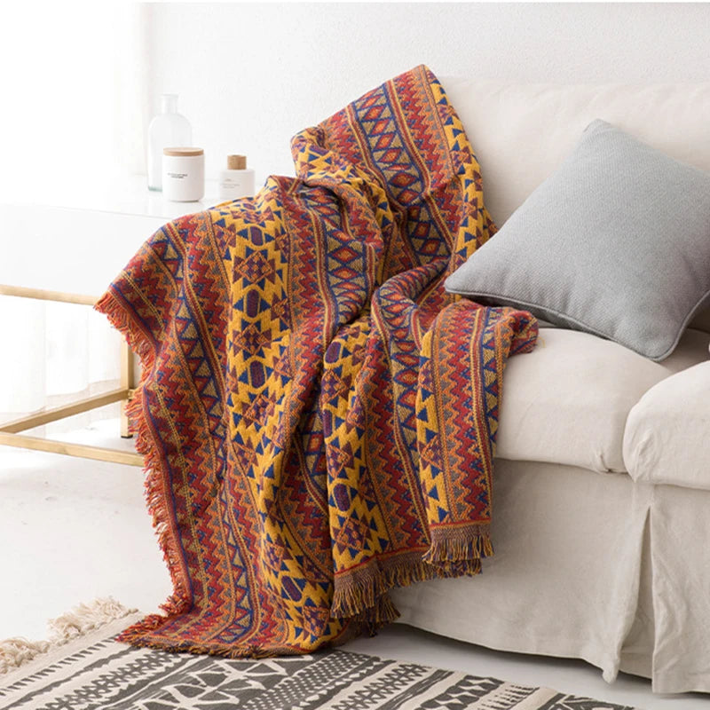 Boho geometric Aztec throw blanket with tassels, featuring earthy tones and a woven texture—perfect for cozy home decor