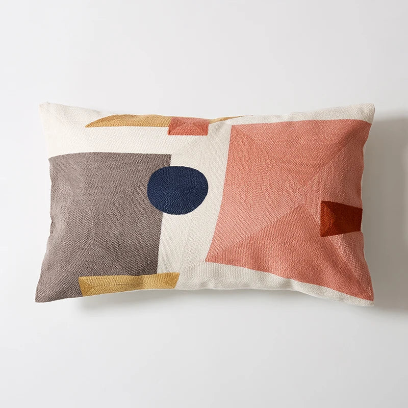 Decorative pillow with geometric pattern on a white background Colorful abstract geometric embroidered cushion cover in cotton blend, decorative pillowcase for living room, kids’ room, or boho home decor.
