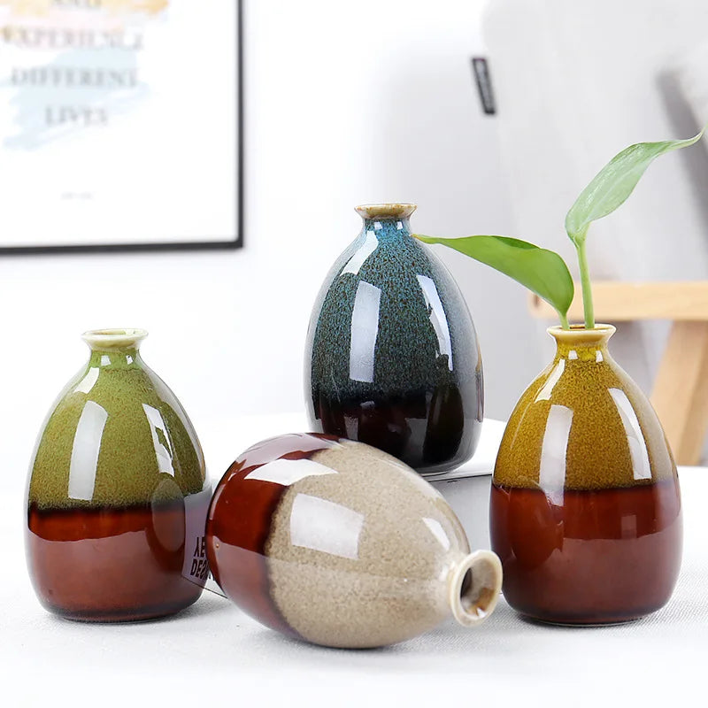Set of ceramic boho vases with multicolored glaze on a white surface.