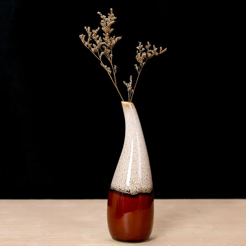 Decorative boho vase with a two-tone design on a wooden surface and black background