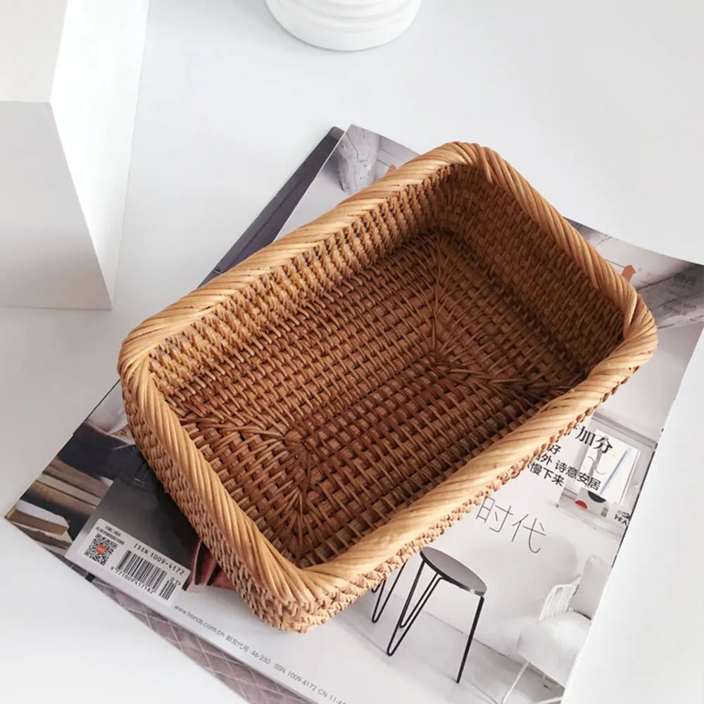 Woven bread basket on a magazine with a white background boho home decor, rattan basket, handwoven wicker basket, fruit storage box, bread basket, picnic basket, natural storage bin, tea storage box, rustic home organization, farmhouse decor, housewarming gift, boho storage basket
