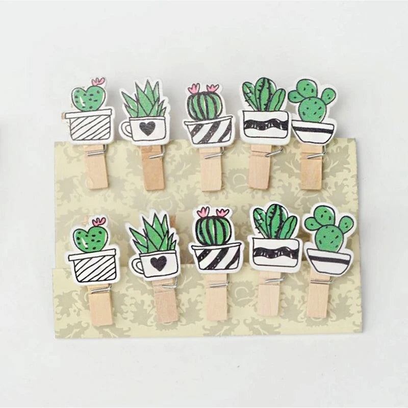 Set of wooden clothespins with cactus designs on a cardboard backing.