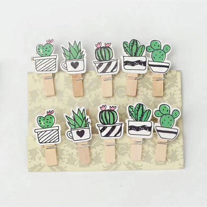 Set of wooden clothespins with cactus designs on a cardboard backing.