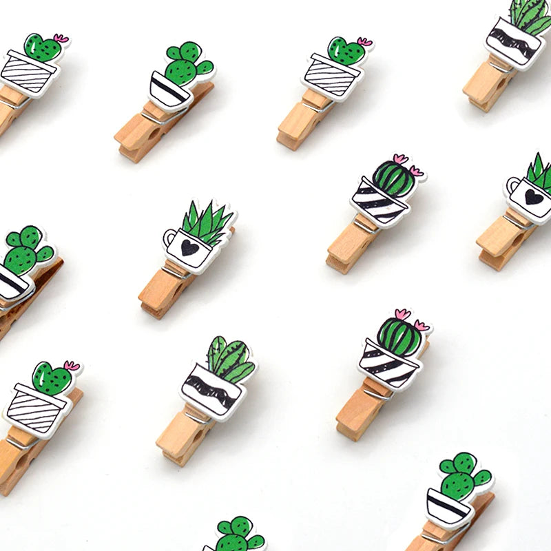 Wooden clips with cactus designs on a white background