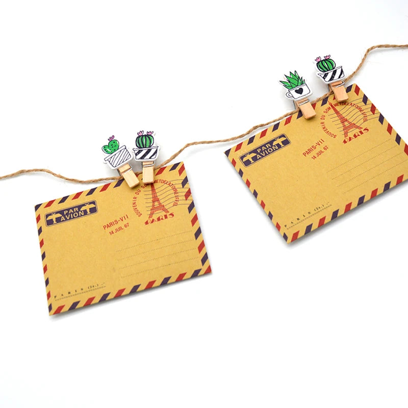 Decorative string with air mail envelope clips on a white background