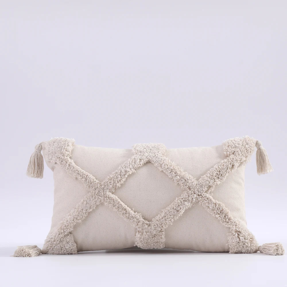 Decorative pillow with tassels on a light gray background