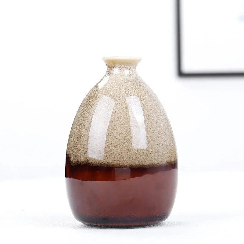 Decorative cream coloured bohemian vase with gradient design on a white background