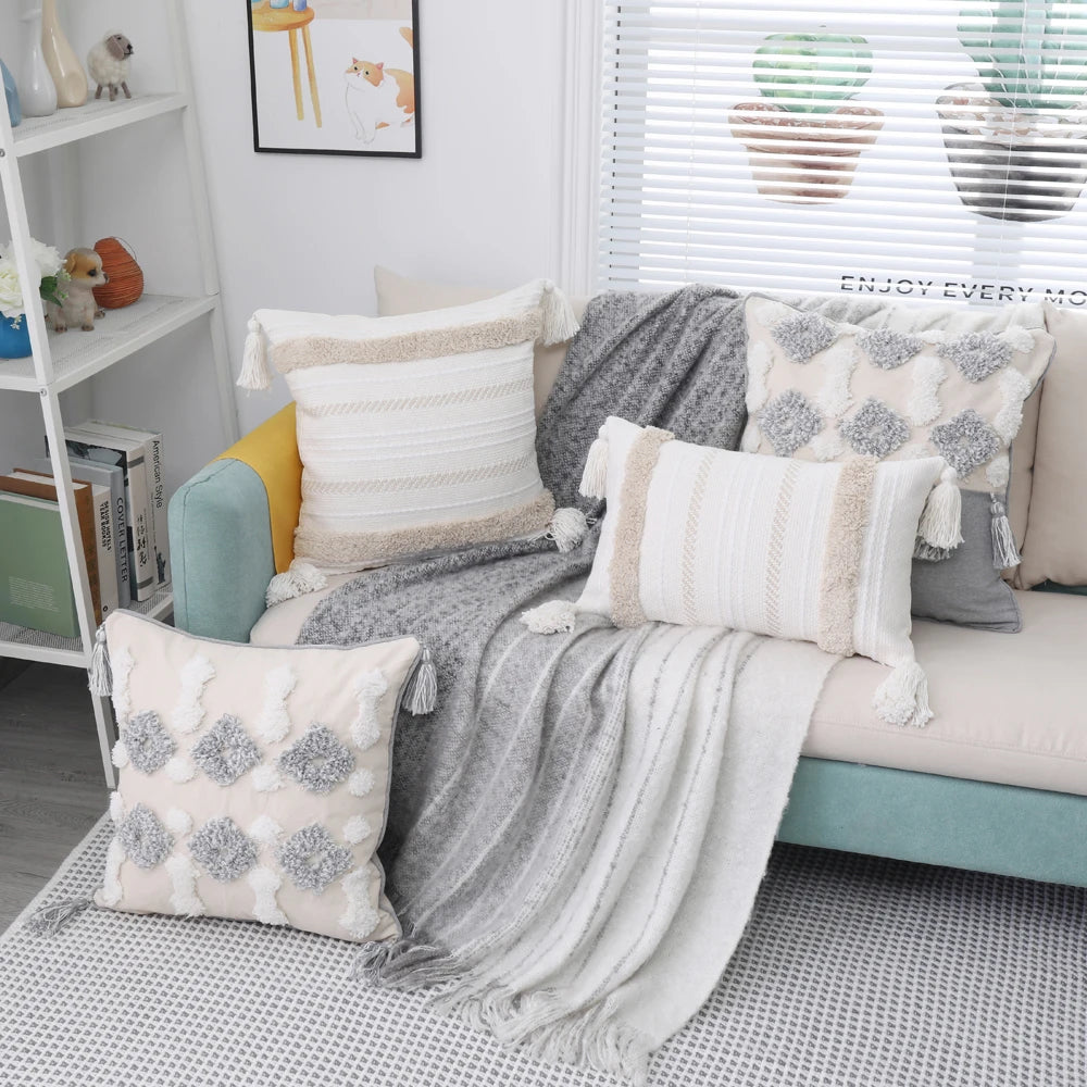 Cozy living room with a teal sofa adorned with patterned cushions and a gray throw blanket.