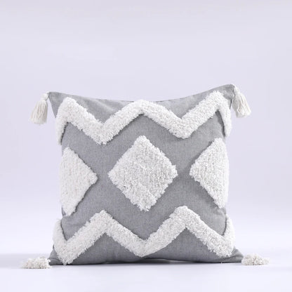 Gray pillow with white zigzag pattern on a light gray background
